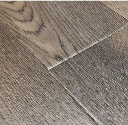 Close detail of wood grain and a pressed-bevel flooring edge.